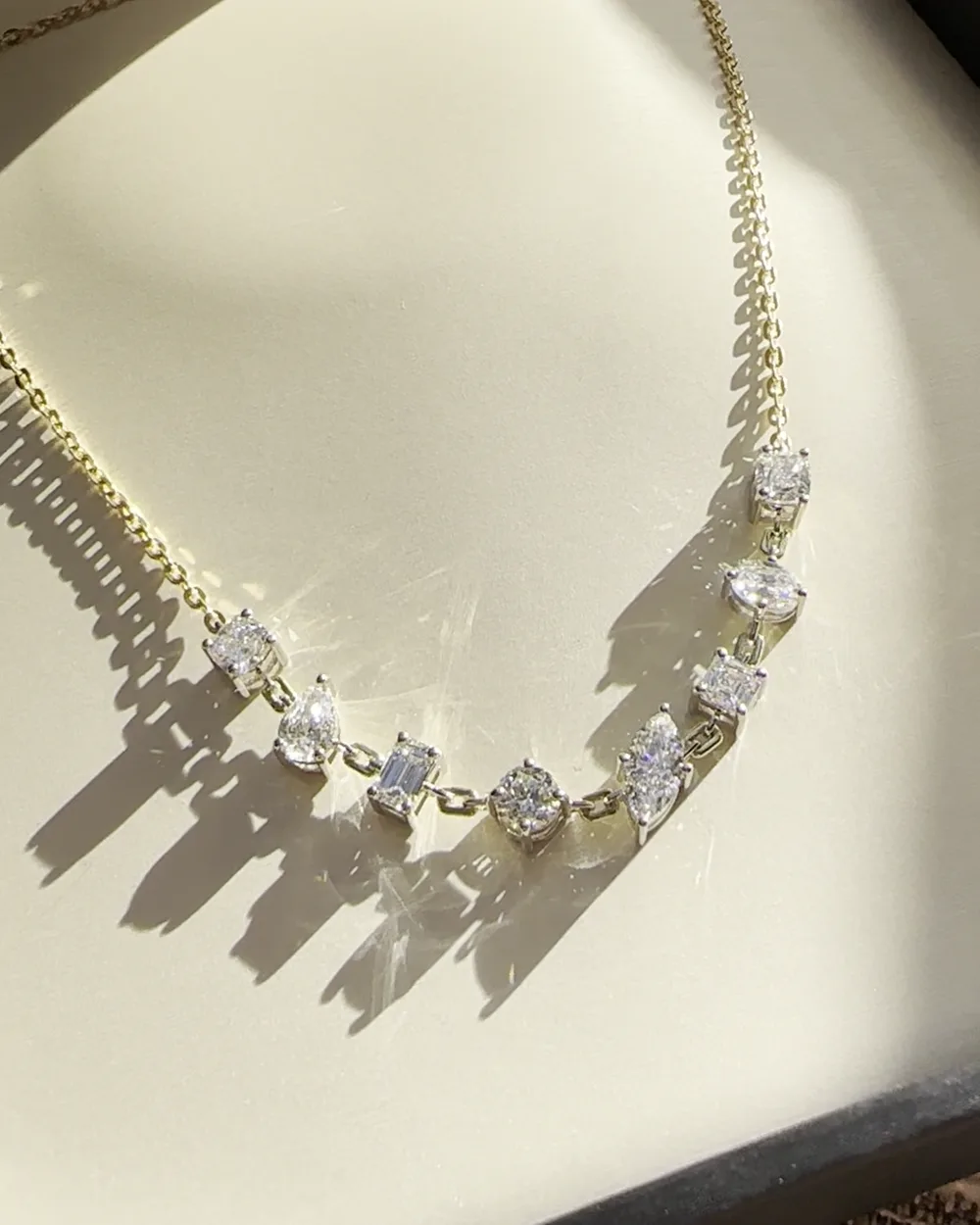 A bespoke gold and diamond necklace in daylight