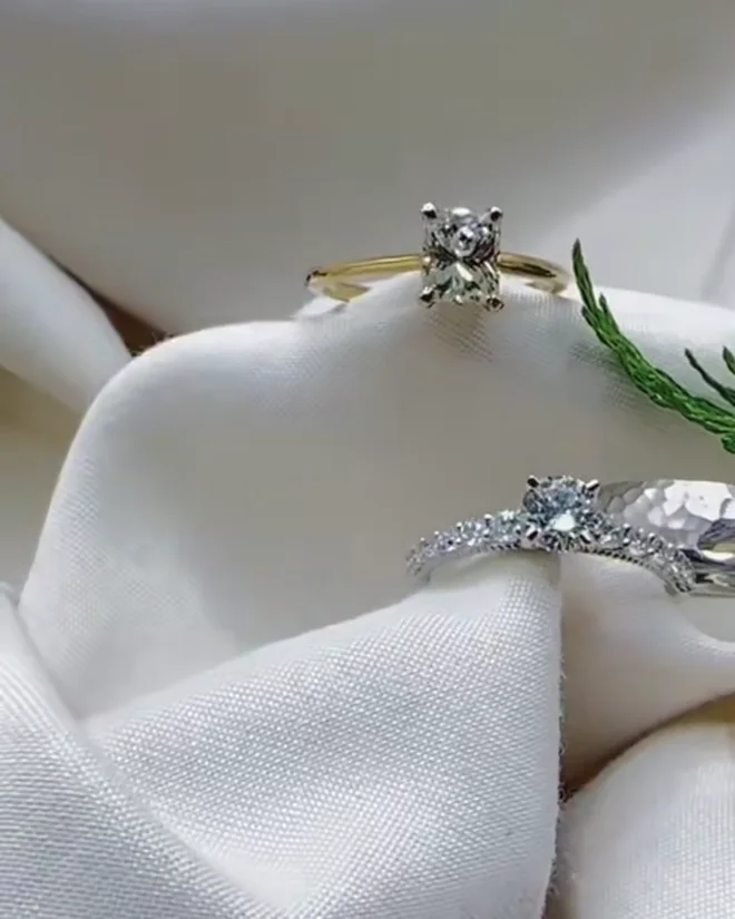 Diamond rings resting on soft silk in the studio