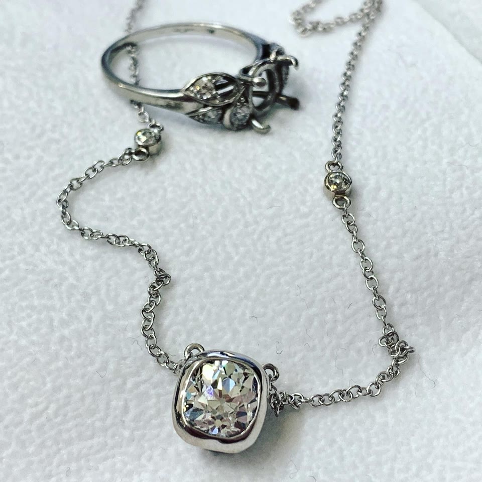 White gold chain with diamond pendant and an heirloom ring